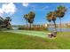 A shuffleboard court next to a lake featuring benches, perfect for outdoor recreation at 3072 Lake Bayshore Dr # 119, Bradenton, FL 34205