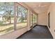 Bright sunroom with large windows overlooking the landscape and the trees at 3072 Lake Bayshore Dr # 119, Bradenton, FL 34205