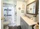 Bathroom featuring a modern vanity and fresh shower curtain, creating a clean and stylish space at 3402 Shingle Oak Ter, Sarasota, FL 34237