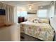 Bedroom with a floral bedspread, complemented by soft lighting and a ceiling fan for a comfortable and restful atmosphere at 3402 Shingle Oak Ter, Sarasota, FL 34237