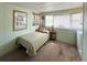 Bright bedroom featuring a twin bed, large bay window, and neutral walls for customization at 3402 Shingle Oak Ter, Sarasota, FL 34237