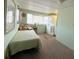 Bedroom with a twin bed and large window, plus a washer/dryer combo for easy laundry at 3402 Shingle Oak Ter, Sarasota, FL 34237
