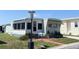 Inviting exterior view of home, highlighting the sunroom, awning, and manicured front yard at 3402 Shingle Oak Ter, Sarasota, FL 34237