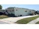 Home featuring a spacious driveway and well-maintained exterior with lush greenery at 3402 Shingle Oak Ter, Sarasota, FL 34237