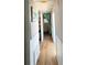 Hallway with wood-look flooring, leading to other rooms and providing easy access throughout the home at 3402 Shingle Oak Ter, Sarasota, FL 34237