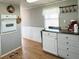 Functional kitchen with light gray walls, white cabinets, and wood-look flooring, offering a practical cooking environment at 3402 Shingle Oak Ter, Sarasota, FL 34237