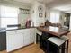 An open kitchen area with a breakfast bar and additional seating, seamlessly connecting to the cozy living area at 3402 Shingle Oak Ter, Sarasota, FL 34237