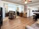 Spacious living area with hardwood floors, offering a view of the kitchen at 3402 Shingle Oak Ter, Sarasota, FL 34237
