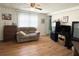 Comfortable living room with wood floors, a plush sofa, and abundant natural light at 3402 Shingle Oak Ter, Sarasota, FL 34237