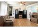 Inviting living room with hardwood floors, neutral decor, and cozy furniture arrangement at 3402 Shingle Oak Ter, Sarasota, FL 34237