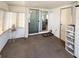 Cozy sunroom with natural light, sliding glass doors, and comfortable carpeting at 3402 Shingle Oak Ter, Sarasota, FL 34237