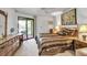 Inviting bedroom featuring a comfortable bed, dresser, and access to a private balcony at 3500 El Conquistador Pkwy # 128, Bradenton, FL 34210