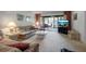A bright living room that opens to the enclosed porch at 3500 El Conquistador Pkwy # 128, Bradenton, FL 34210
