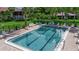 Community pool with lounge chairs and well-maintained brick surround at 3500 El Conquistador Pkwy # 128, Bradenton, FL 34210