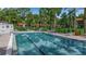 Community pool with lounge chairs and clear water, surrounded by greenery at 3500 El Conquistador Pkwy # 128, Bradenton, FL 34210