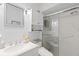 Clean bathroom with glass shower door, granite vanity, and storage at 3500 El Conquistador Pkwy # 132, Bradenton, FL 34210