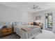 Bright bedroom with carpet, ceiling fan, and sliding door to patio at 3500 El Conquistador Pkwy # 132, Bradenton, FL 34210
