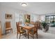 Open dining room with natural light, shuttered windows, and garden view at 3500 El Conquistador Pkwy # 132, Bradenton, FL 34210