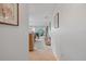 Bright hallway leads to living area with tile floors and light walls at 3500 El Conquistador Pkwy # 132, Bradenton, FL 34210