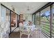 Well-lit sunroom boasts a neutral color palette and charming decor at 3500 El Conquistador Pkwy # 132, Bradenton, FL 34210