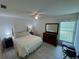 Bright bedroom with light-colored flooring and white walls and a ceiling fan at 3752 Collins St # 508, Sarasota, FL 34232
