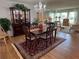 Elegant dining room features a crystal chandelier, wood floors, and sophisticated furnishings at 3752 Collins St # 508, Sarasota, FL 34232