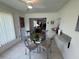Bright dining area with glass table and views into the living room at 3752 Collins St # 508, Sarasota, FL 34232