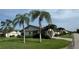 Charming single-story home with mature palm trees and lush green lawn at 3752 Collins St # 508, Sarasota, FL 34232