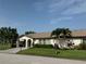 Inviting single-story home featuring well-manicured lawn, colorful landscaping, and covered carport at 3752 Collins St # 508, Sarasota, FL 34232