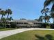 Attractive community building with stone accents, manicured landscaping, and circular driveway at 3752 Collins St # 508, Sarasota, FL 34232