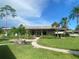Charming single-story home with well-manicured lawn, walkway, and tropical landscaping at 3752 Collins St # 508, Sarasota, FL 34232