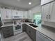 Bright kitchen with white cabinets, granite countertops and stainless steel sink at 3752 Collins St # 508, Sarasota, FL 34232