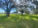 Picturesque lawn with mature trees, offering a serene view of the surrounding community homes at 3752 Collins St # 508, Sarasota, FL 34232