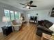 Cozy living room with plush seating, wood floors, and plantation shutters at 3752 Collins St # 508, Sarasota, FL 34232