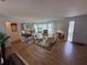 Bright and airy living room with wood flooring, large mirrors, and comfortable seating at 3752 Collins St # 508, Sarasota, FL 34232