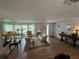 Bright and airy living room with wood flooring, large mirrors, and comfortable seating at 3752 Collins St # 508, Sarasota, FL 34232