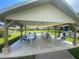 Outdoor covered seating area with tables and chairs for community gatherings at 3752 Collins St # 508, Sarasota, FL 34232