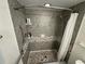 Shower features gray tile, mosaic accents, and a shower curtain at 3752 Collins St # 508, Sarasota, FL 34232