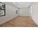 Spacious bedroom with tray ceiling, wood-look tile, and windows on two walls at 3865 Everglades Ter, North Port, FL 34286