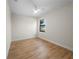 Cozy bedroom featuring wood-look tile floors, a ceiling fan, and a window at 3865 Everglades Ter, North Port, FL 34286