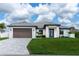 Beautiful single-Gathering home with a two-car garage, well-kept lawn, and freshly-paved driveway at 3865 Everglades Ter, North Port, FL 34286