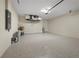 Garage interior featuring epoxy floor, utility sink and water heater at 3865 Everglades Ter, North Port, FL 34286