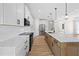 Open kitchen with stainless steel appliances, quartz countertops, and light wood flooring at 3865 Everglades Ter, North Port, FL 34286