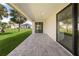 Covered outdoor patio area with stone pavers and a ceiling fan at 3865 Everglades Ter, North Port, FL 34286