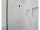 Close-up of the shower with white marble tile and built-in shelving niche at 3865 Everglades Ter, North Port, FL 34286