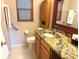 Bathroom featuring granite countertops, wooden cabinets, and modern fixtures at 390 301 W Blvd # 2C, Bradenton, FL 34205