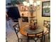 Charming dining area featuring a round table with four chairs, adjacent to built-in shelving at 390 301 W Blvd # 2C, Bradenton, FL 34205