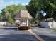 Welcoming entrance to the community with a gated entry and lush landscaping at 390 301 W Blvd # 2C, Bradenton, FL 34205