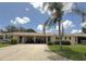 Inviting home with a convenient carport and a lush green lawn with a mature palm tree at 390 301 W Blvd # 2C, Bradenton, FL 34205
