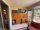 This Florida room is furnished with cabinets, TV and colorful chairs, offering indoor-outdoor living at 390 301 W Blvd # 2C, Bradenton, FL 34205